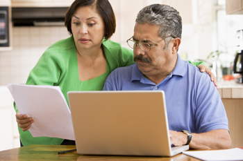 couple-in-kitchen-with-laptop-and-paperwork--350x233.jpg